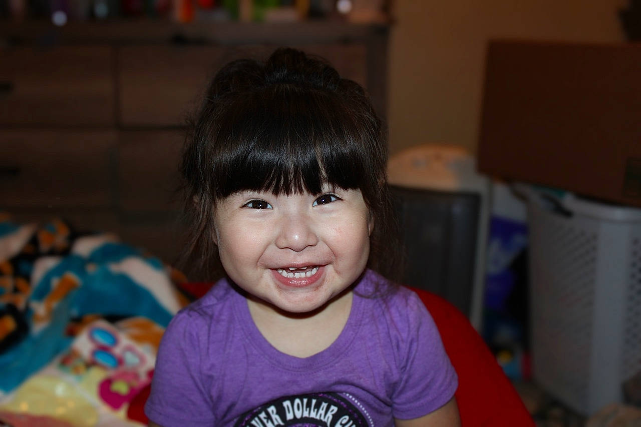 Faith joined the competition — help win amazing prizes! bangs, black_hair, cheek, child, eye, eyelash, face, facial_expression, fun, happy, hime_cut, iris, joy, leisure, nose, person, room, sitting, skin, smile