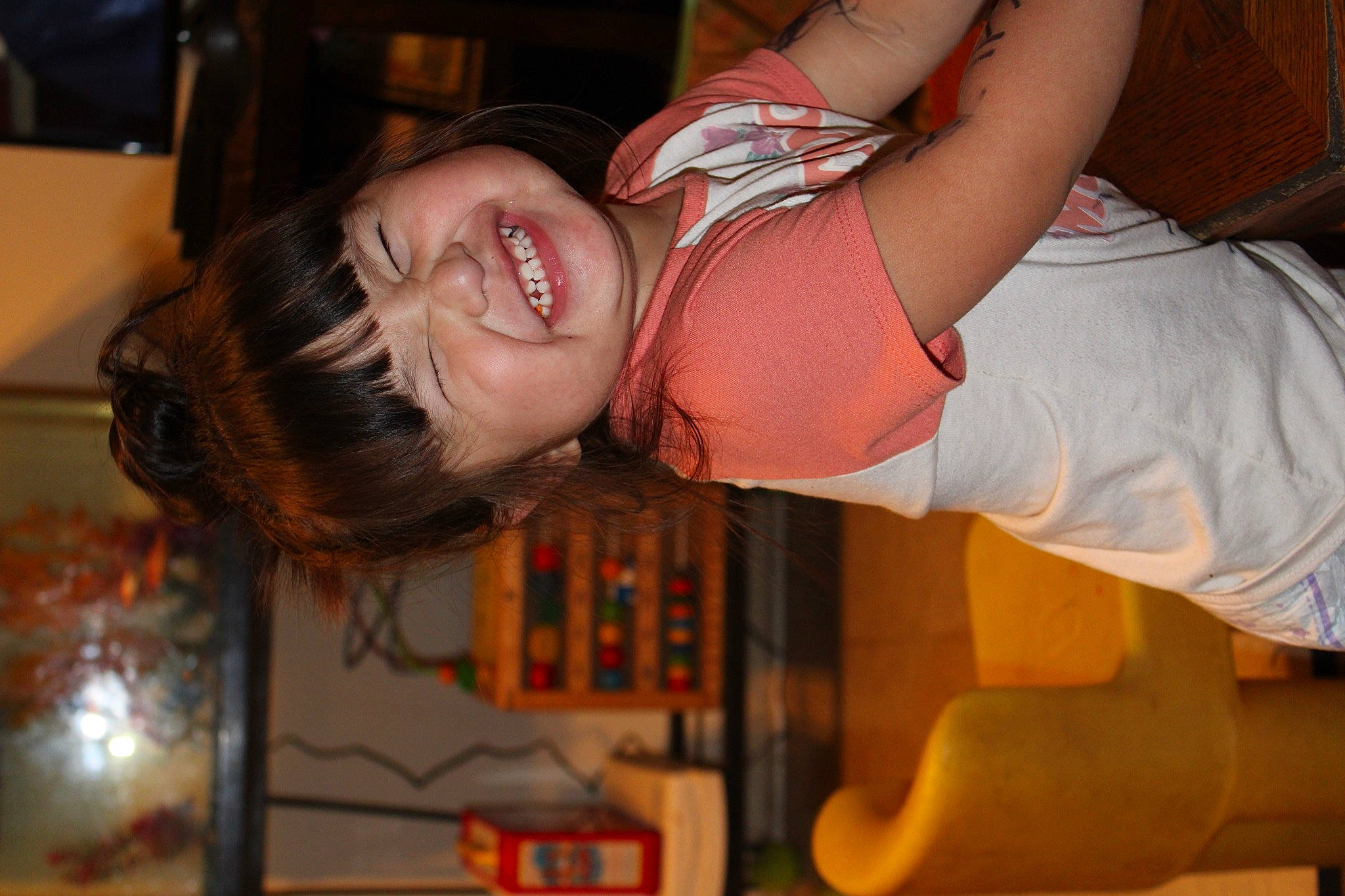 Faith is registered to the contest to win money with this photo: abdomen, arm, black_hair, chest, child, ear, elbow, event, fun, happy, human_leg, joy, mouth, nose, orange, organ, person, smile, t_shirt, tableware