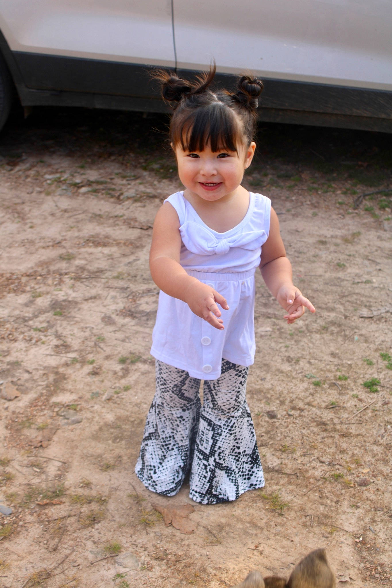 Faith joined the competition — help win amazing prizes! baby_toddler_clothing, barefoot, body_of_water, child, fun, grass, happy, joy, landscape, leisure, pattern, people_in_nature, person, play, sand, sitting, sleeve, smile, soil, t_shirt