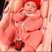 Kylie joined the competition — help win amazing prizes! baby, car_seat, child, clothing, cozy, cute, indoor, infant, person, pink_clothing, portrait, purple_bows, red_headband, safety, seat, seatbelt, sitting, small, smiling, young_child