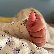 Kylie is registered to the contest to win money with this photo: baby_hand, thumbs_up, close_up, infant, cute, floral_pattern, blanket, sleeve, soft_texture, skin, baby_clothing, tiny_fingers, warm, comfort, cozy, child, infancy, hand_gesture, fingers, newborn