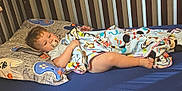 Zayden joined the competition — help win amazing prizes! toddler, crib, blanket, pacifier, pillow, bed, child, sleeping, comfort, blue, cartoon_characters, indoor, young_child, resting, bedroom, soft_toys, sleepwear, head, face, legs