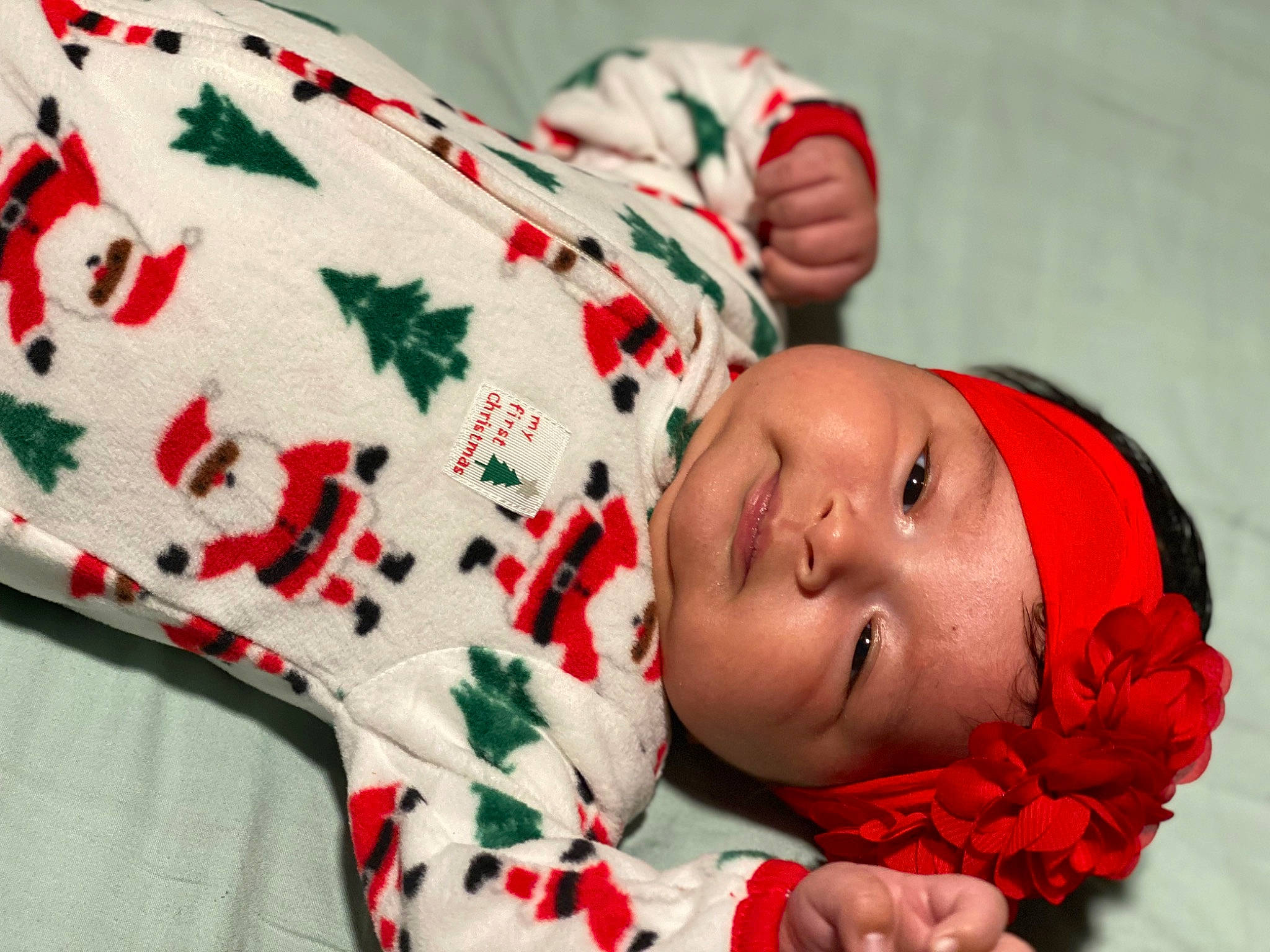 Andrea is registered to the contest to win money with this photo: arm, baby, baby_sleeping, baby_toddler_clothing, carmine, child, comfort, face, fashion_accessory, finger, happy, headwear, linens, lip, pattern, person, red, skin, sleeve, sock