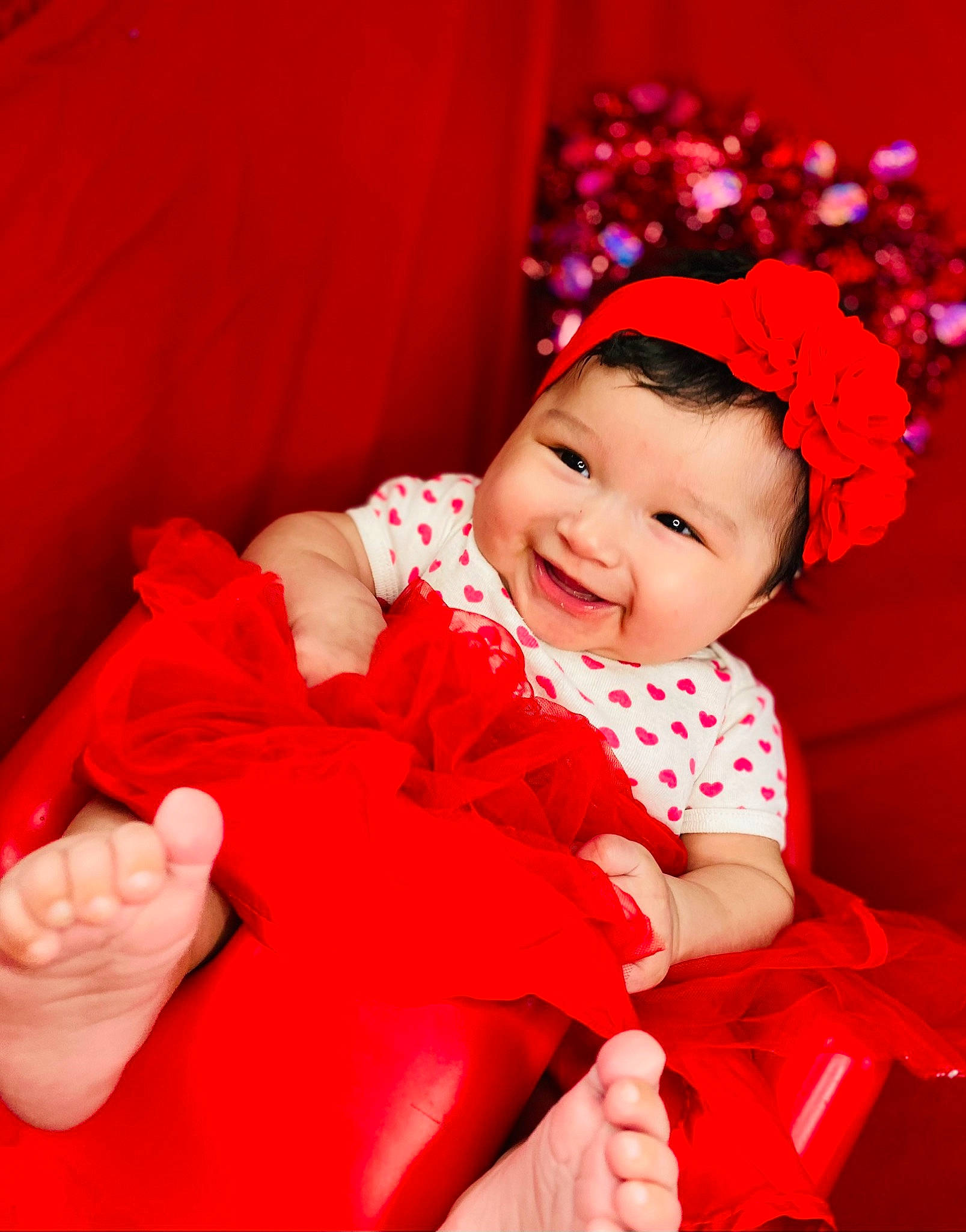 Andrea joined the competition — help win amazing prizes! baby, baby_laughing, baby_toddler_clothing, curtain, event, flash_photography, fun, gesture, happy, headgear, headwear, holiday, human_body, joy, magenta, person, petal, pink, plant, red