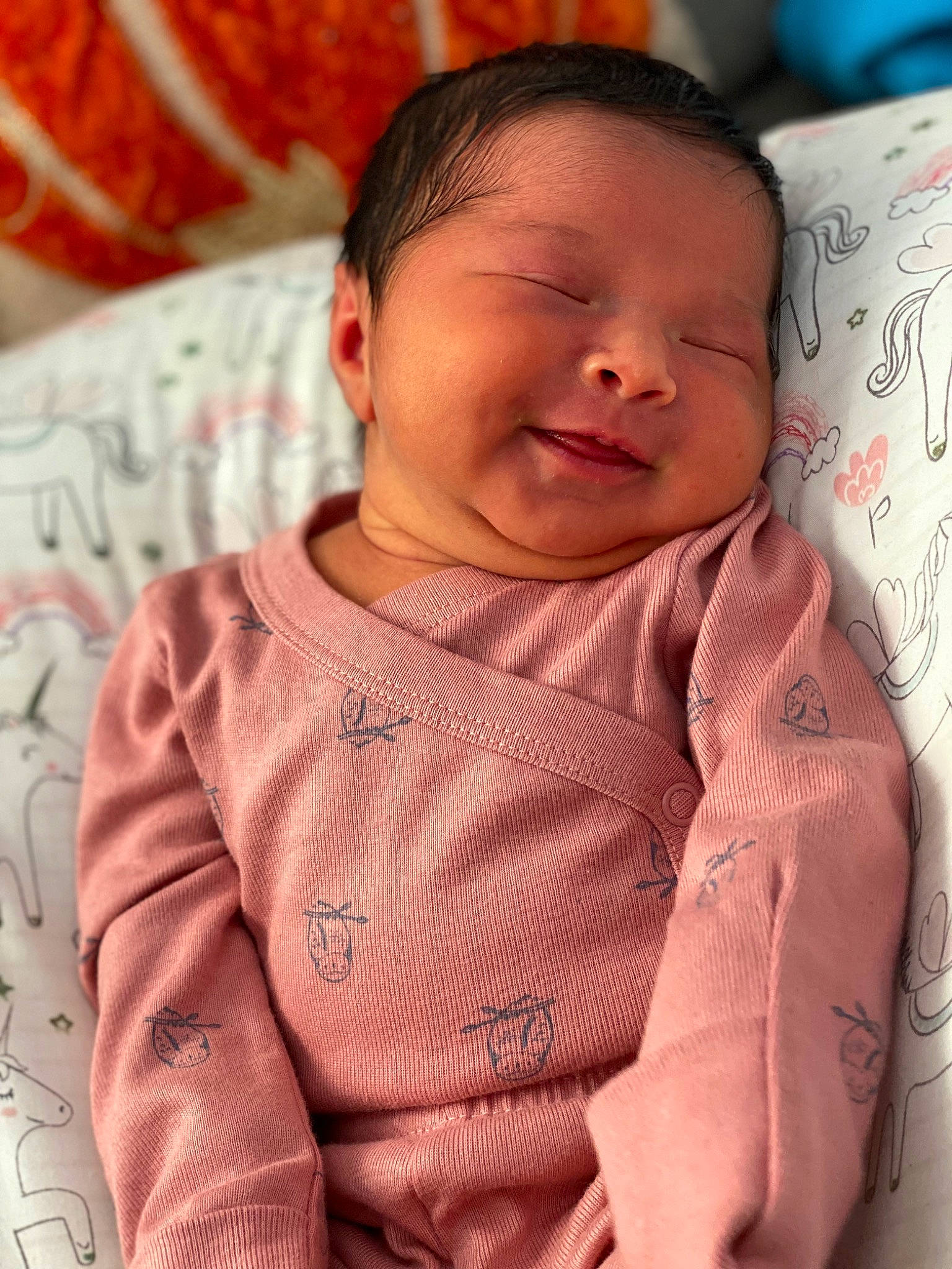 Andrea is registered to the contest to win money with this photo: baby, cheek, chin, collar, comfort, face, finger, forehead, happy, head, lip, mouth, neck, nose, orange, outerwear, person, pink, skin, sleeve