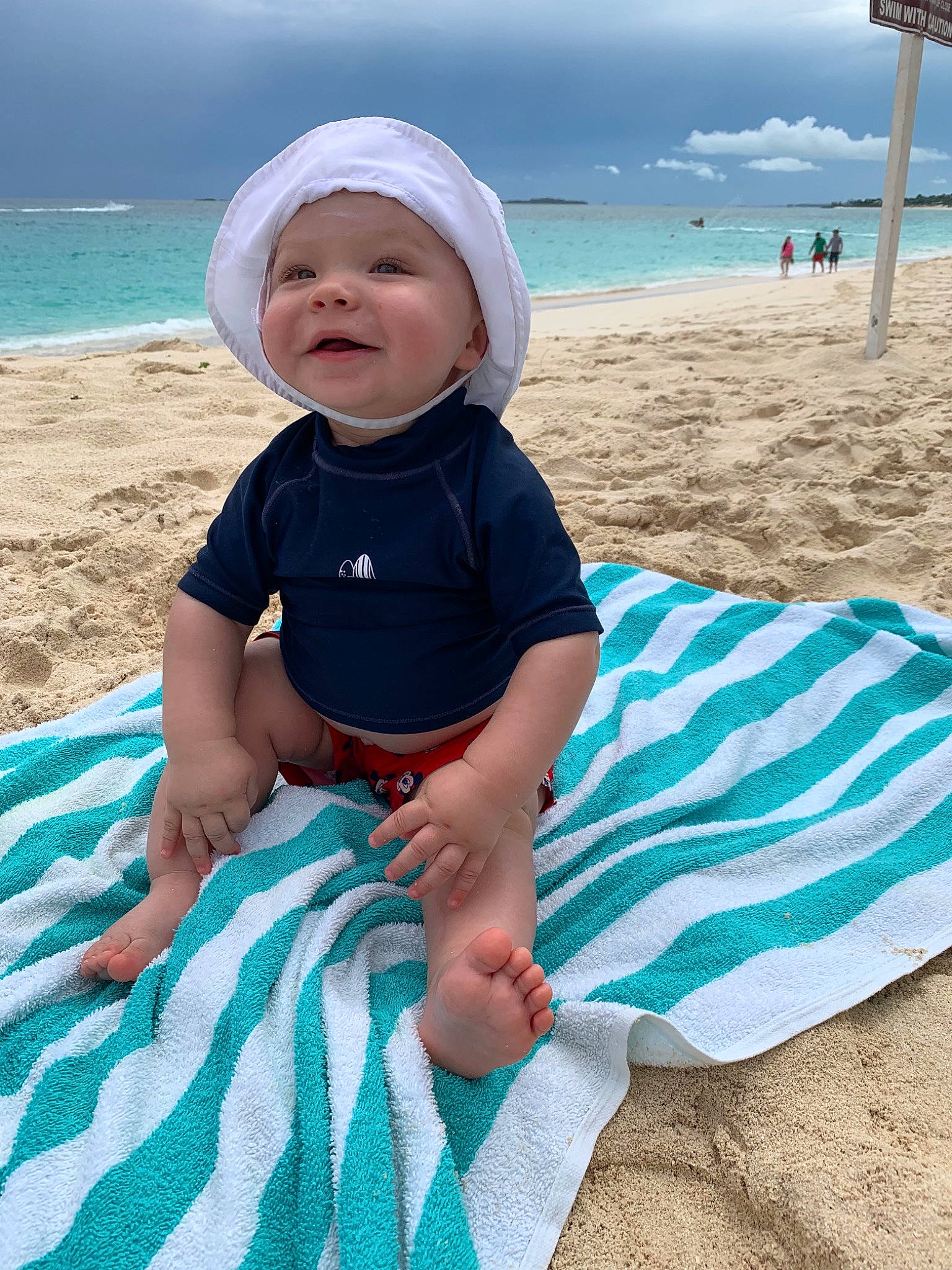 Ian Carlos is registered to the contest to win money with this photo: baby, beach, child, fun, headgear, headwear, holiday, leg, leisure, linens, ocean, person, product, sea, sky, smile, summer, sun_hat, textile, toddler