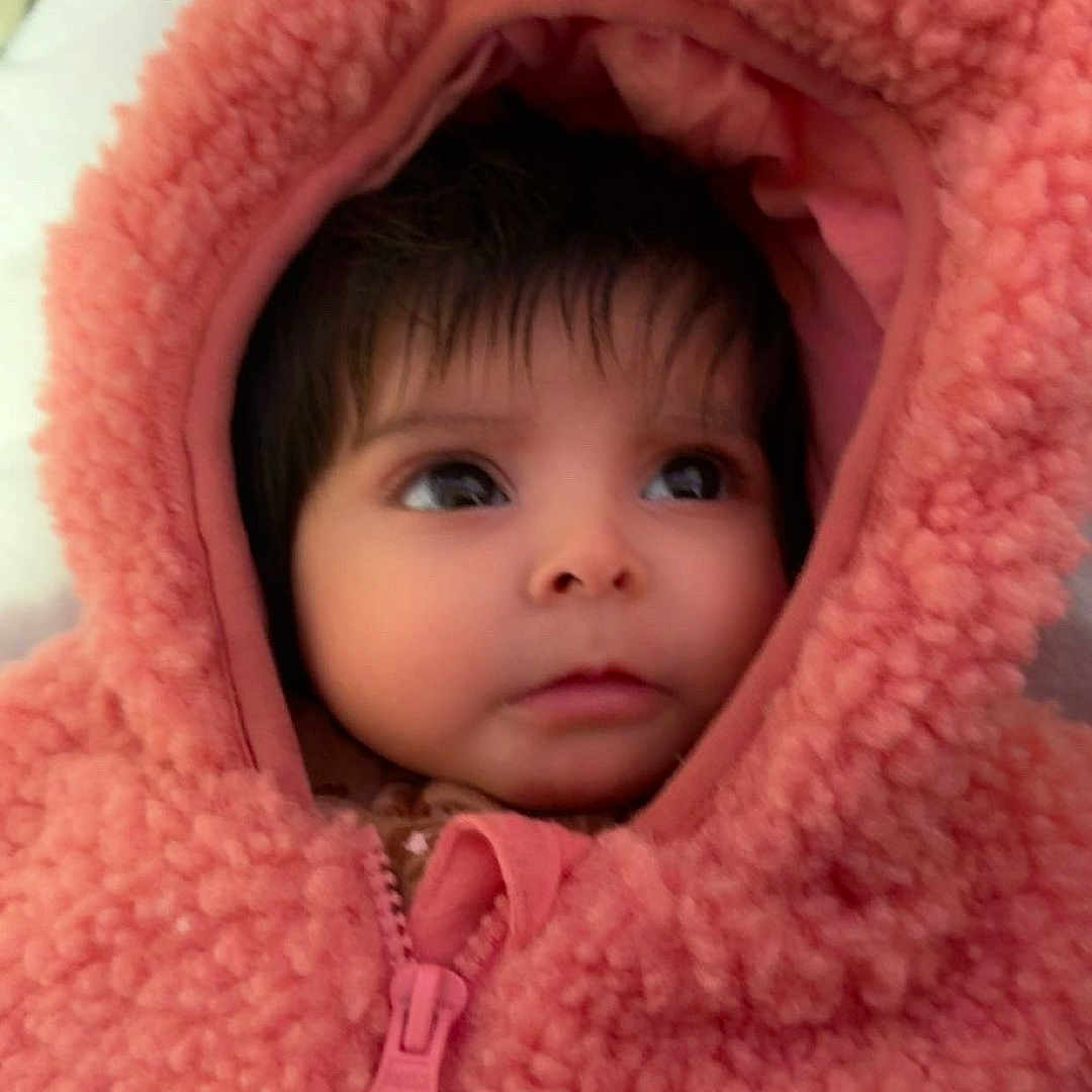 Gracie Marie joined the competition — help win amazing prizes! baby, child, clothing, cozy, cute, eyes, face, fur, headwear, hood, indoor, infant, jacket, person, pink, portrait, soft, warm, young, zipper