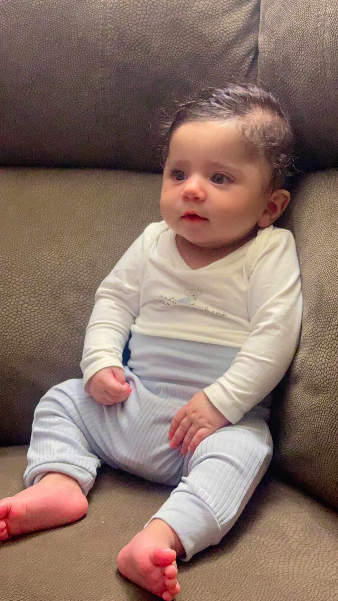 Avitaaj Singh joined the competition — help win amazing prizes! baby, barefoot, blue_pants, child, clothing, comfort, couch, curly_hair, cute, face, feet, furniture, hands, indoors, infant, portrait, sitting, skin, white_shirt, young_child