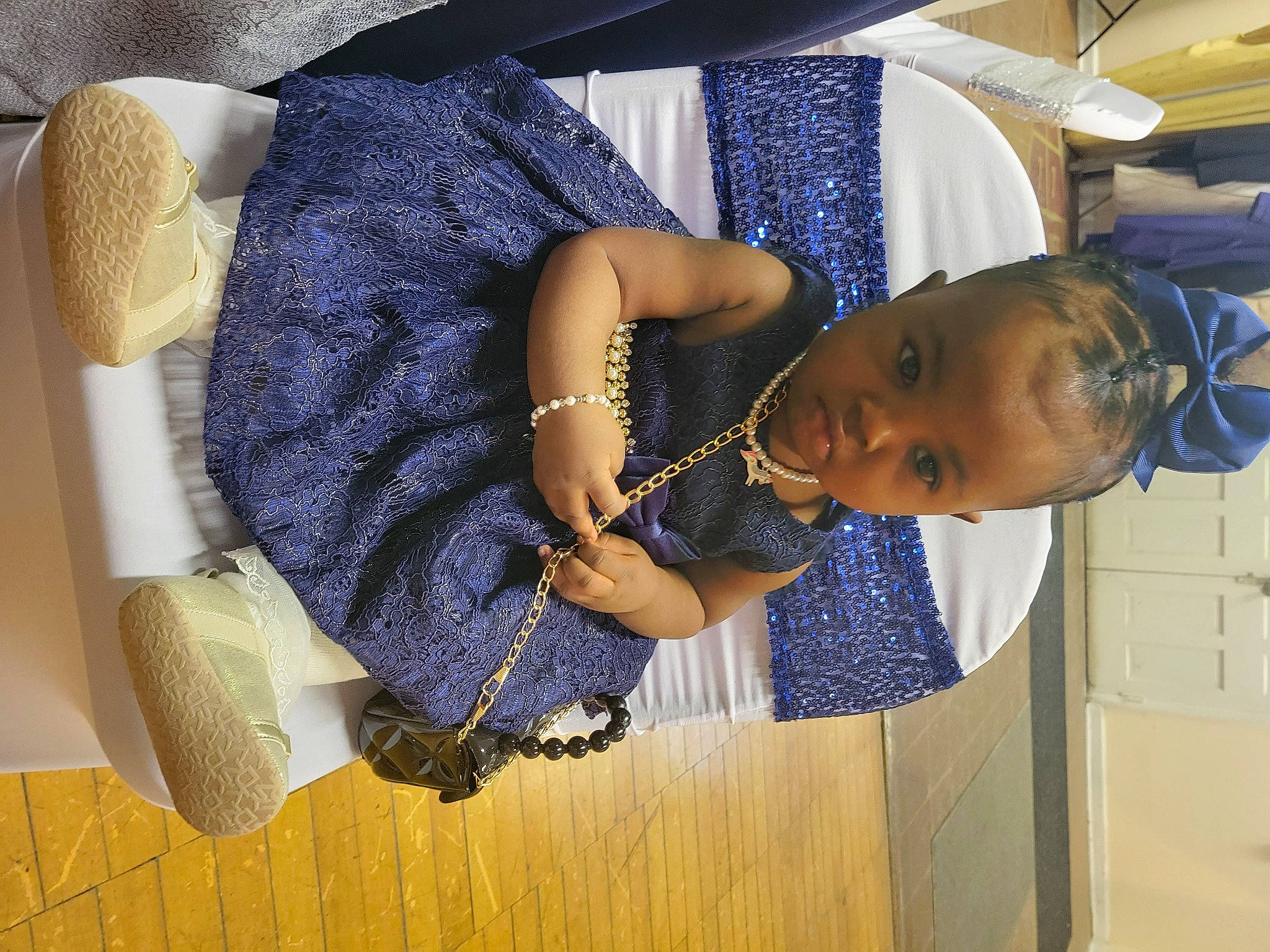 Jai'Dah is registered to the contest to win money with this photo: black_hair, child, comfort, elbow, electric_blue, fashion_accessory, fashion_design, fun, happy, human_leg, jewellery, pattern, person, purple, room, sitting, thigh, trunk, wrist