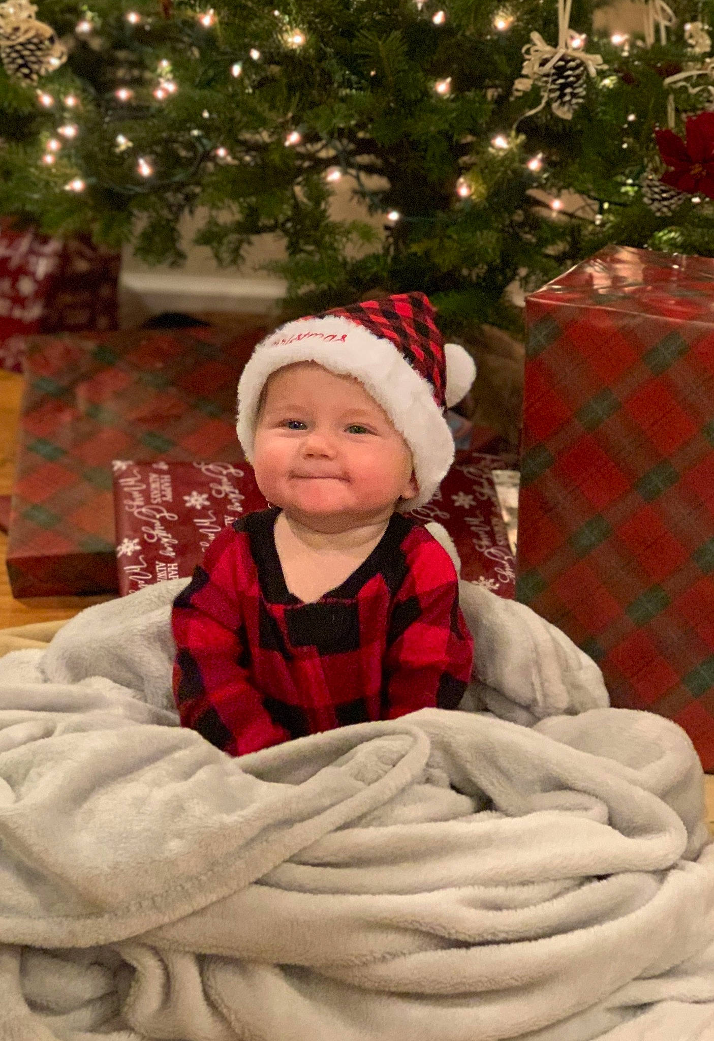 Jonathan is registered to the contest to win money with this photo: baby, baby_toddler_clothing, beauty, child, christmas, christmas_decoration, christmas_ornament, christmas_tree, event, facial_expression, fun, happy, headwear, holiday, joy, person, plant, sleeve, smile, tartan