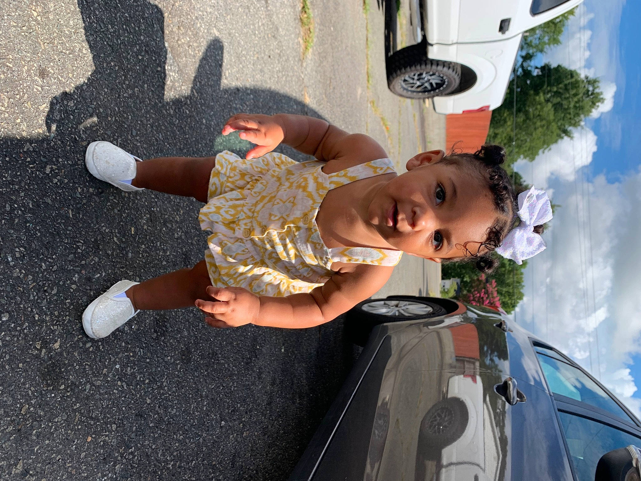 Ahnava Ivette joined the competition — help win amazing prizes! asphalt, auto_part, automotive_design, automotive_exterior, automotive_lighting, bumper, car, cloud, electric_blue, fun, hood, motor_vehicle, person, road_surface, sky, tar, toddler, trunk, vehicle, vehicle_door