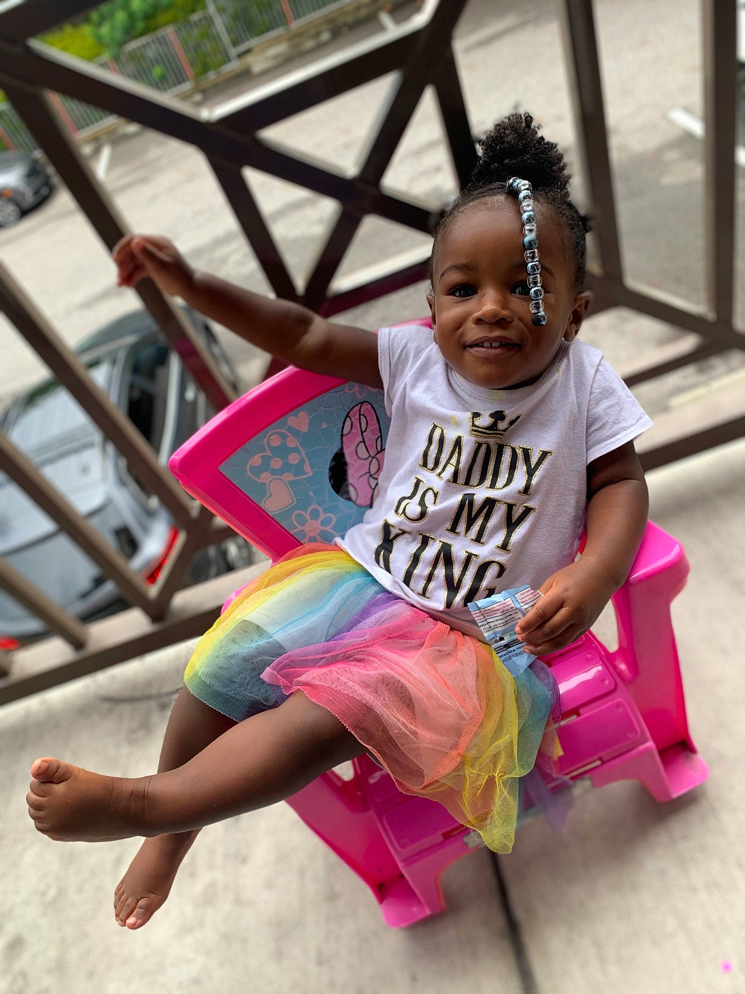 Basily is registered to the contest to win money with this photo: barefoot, child, event, foot, fun, happy, joy, leisure, magenta, mammal, person, pink, public_space, recreation, sandal, shorts, sitting, skin, smile, t_shirt