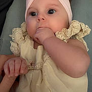 Adelynn is registered to the contest to win money with this photo: baby, infant, child, headband, flower, hand, finger, dress, embroidery, cute, adorable, skin, face, eyes, sitting, indoors, person, holding, closeup, portrait