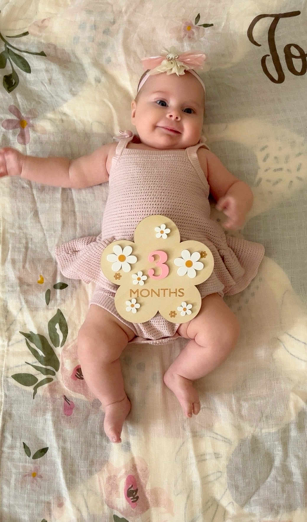 Adelynn joined the competition — help win amazing prizes! baby, infant, smiling, pink_dress, headband, flower_sign, months, lying_down, blanket, floral_pattern, cute, chubby_cheeks, happy, child, indoor, soft_lighting, three_months, adorable, young, portrait