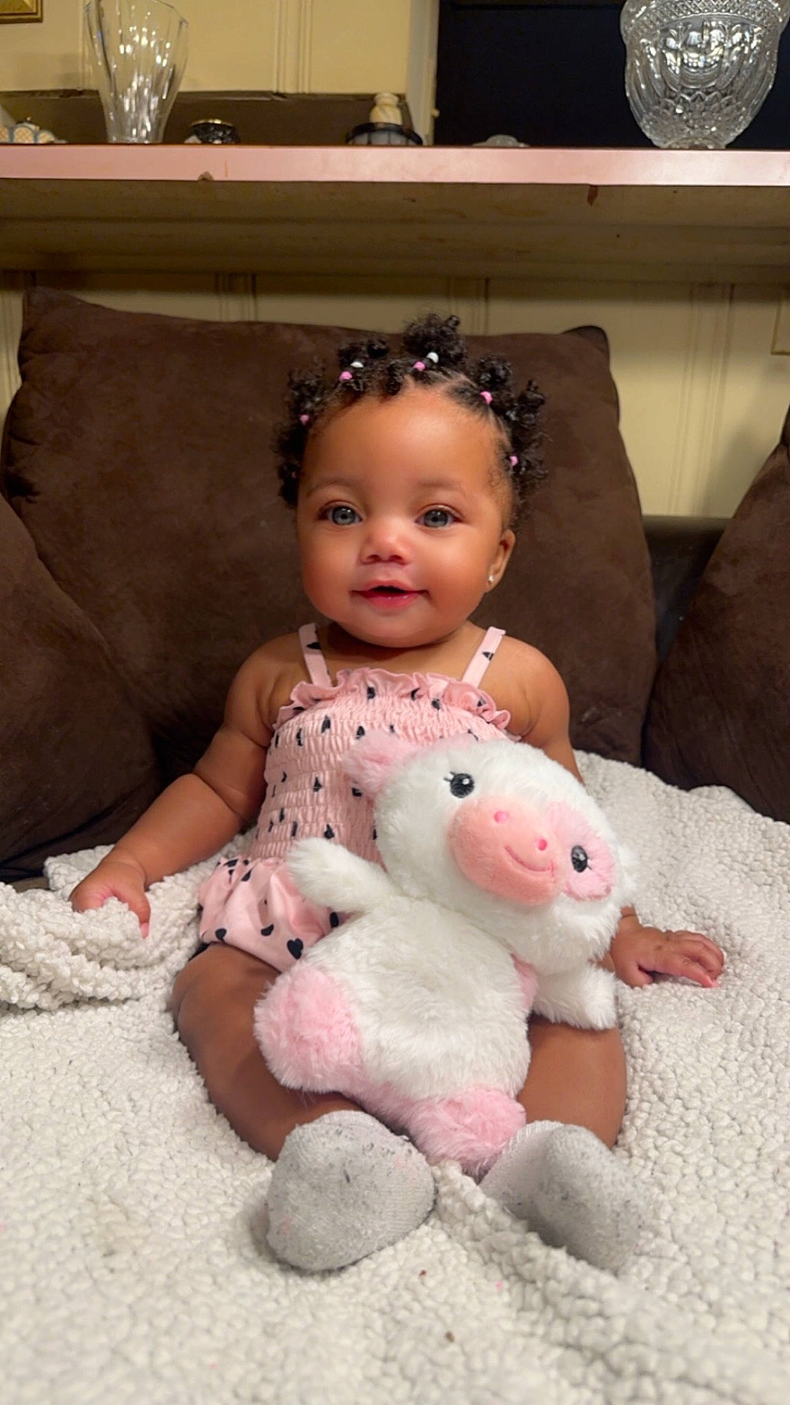 Azia is registered to the contest to win money with this photo: baby, baby_products, baby_toddler_clothing, cheek, child, comfort, couch, dress, embellishment, fashion_accessory, flooring, fun, happy, headpiece, jewellery, linens, person, pink, sitting, toddler