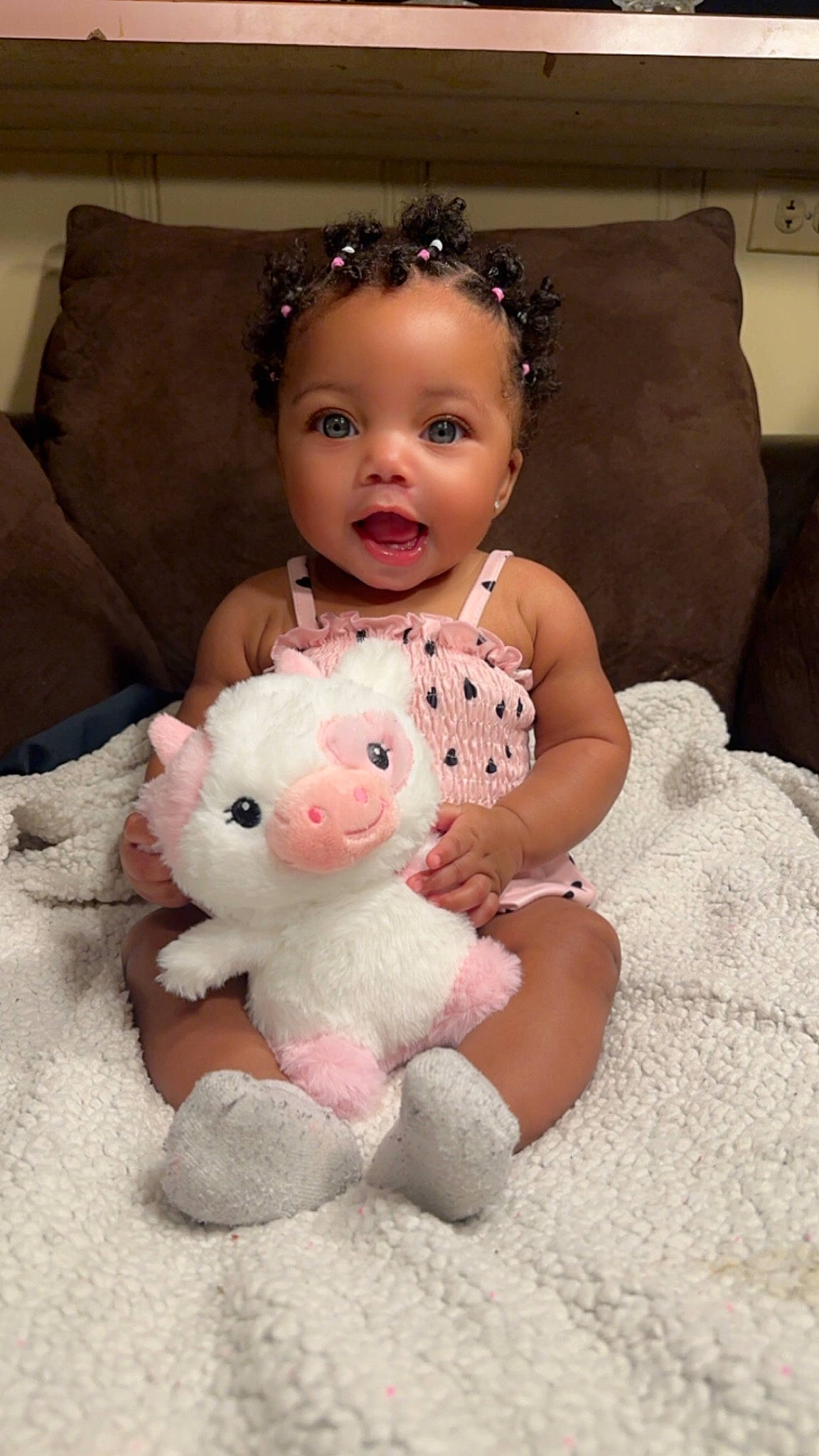 Azia is registered to the contest to win money with this photo: baby_toddler_clothing, cheek, child, comfort, couch, dress, eye, flooring, happy, head, headpiece, leg, nose, person, pink, skin, smile, teddy_bear, textile, toddler