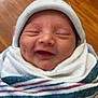 Ashton joined the competition — help win amazing prizes! baby, newborn, smiling, hat, blanket, striped_blanket, cozy, sleepy, face, infant, child, wrapped, cute, person, headwear, happy, indoors, wooden_floor, portrait, resting