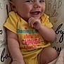 baby, blanket, candid, child, closeup, cozy, cute, expression, face, hand, happy, indoors, infant, playful, portrait, sitting, smiling, soft, yellow_onesie, young_child