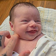 Isaac joined the competition — help win amazing prizes! baby, blanket, button, clothing, cute, expression, face, giraffe_print, hand, happy, human, indoors, infant, newborn, person, skin, smile, tattoo, textile, wood_floor
