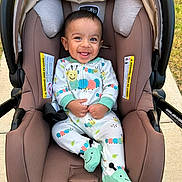 Kridai joined the competition — help win amazing prizes! baby, baby_clothing, baby_garment, car_seat, caterpillar_design, child, cute, fabric, footies, happy, head_support, infant, infant_footwear, onesie, outdoor, person, seatbelt, sitting, smiling, sunlight