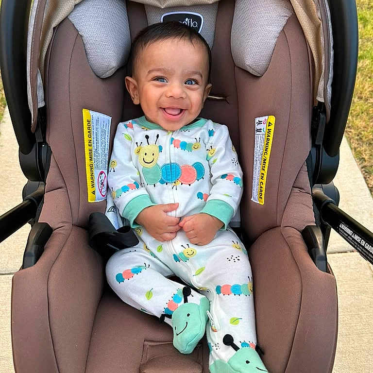 Kridai joined the competition — help win amazing prizes! baby, baby_clothing, baby_garment, car_seat, caterpillar_design, child, cute, fabric, footies, happy, head_support, infant, infant_footwear, onesie, outdoor, person, seatbelt, sitting, smiling, sunlight