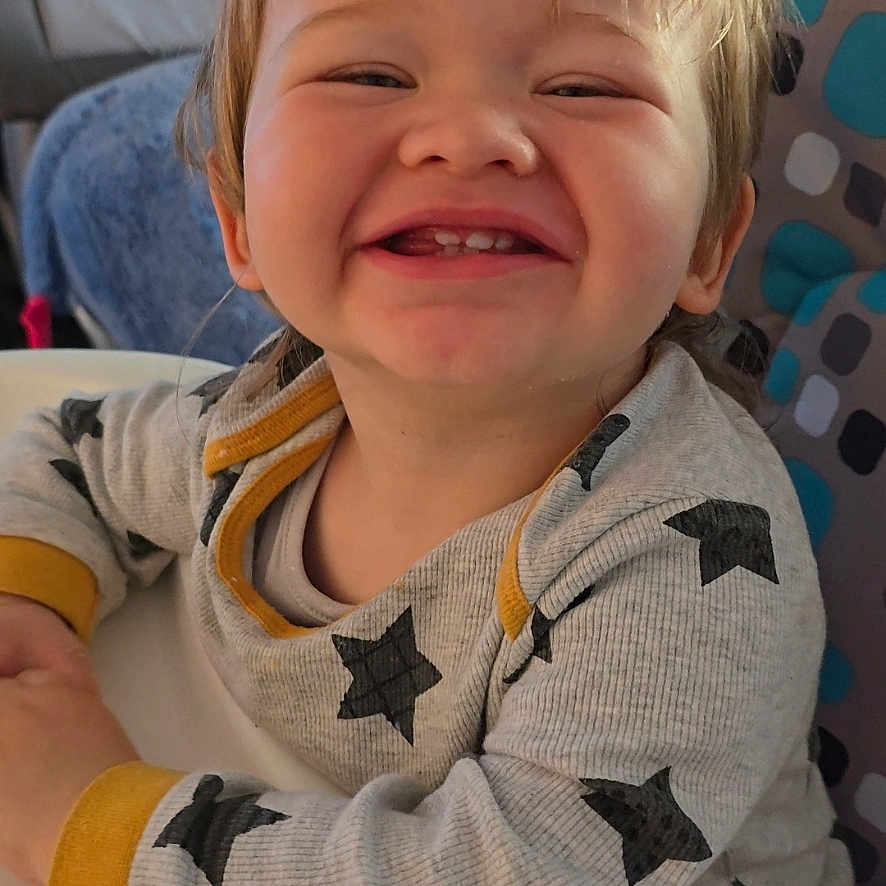 Jacob joined the competition — help win amazing prizes! baby, babylaughing, blonde, bodypart, clothing, couch, face, finger, furniture, hair, hand, happy, head, laughing, mouth, person, photography, portrait, smile, teeth