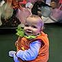 baby, toddler, child, costume, pumpkin, orange, green, smile, happy, indoor, play, balloon, party, festive, cute, sitting, clothing, face, person, fun