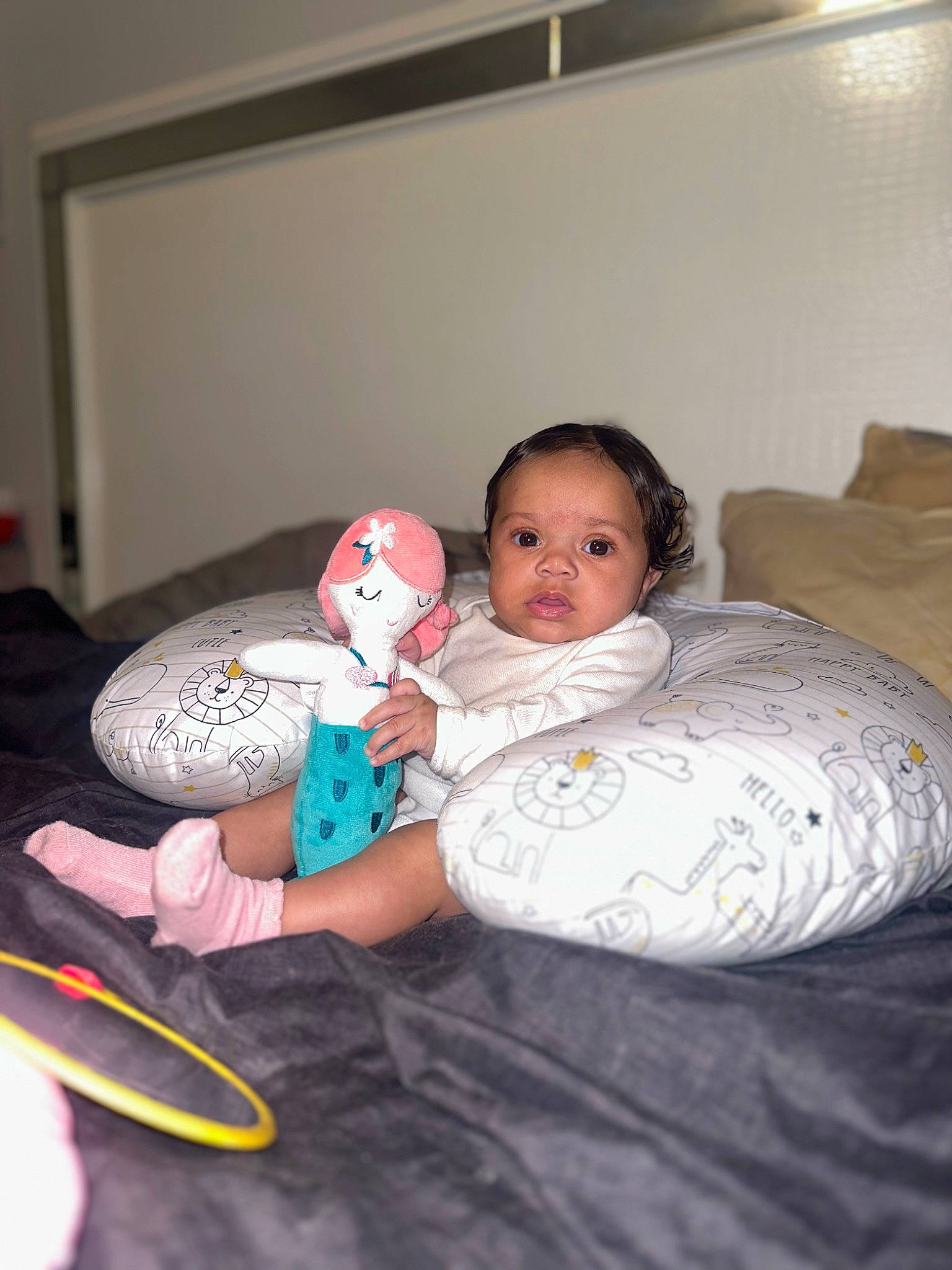 Ivyana is registered to the contest to win money with this photo: baby, baby_toddler_clothing, bed, bedding, bedtime, child, comfort, couch, floor, flooring, fun, happy, linens, person, pillow, room, sitting, t_shirt, textile, throw_pillow