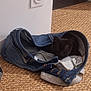 animal, black_kitten, clothing, cozy, curious, cute, denim, fabric, floor, hiding, home, indoor, jeans, pet, playful, resting, shadow, small_animal, texture, woven_rug
