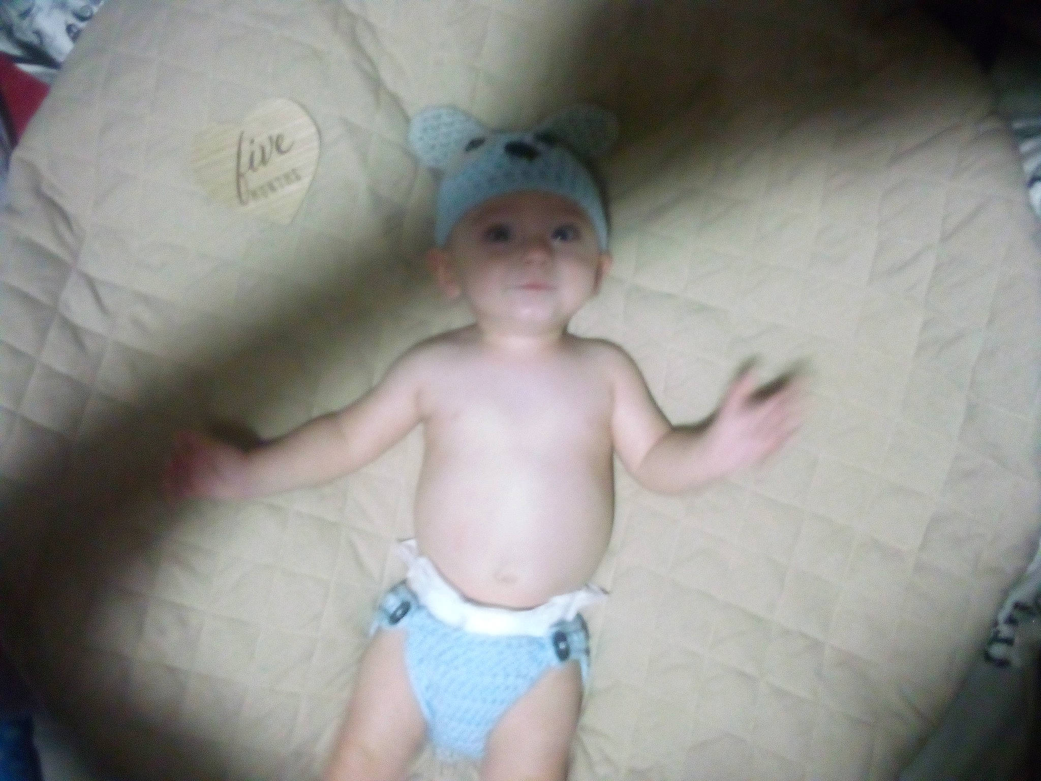 Victor is registered to the contest to win money with this photo: baby, baby_toddler_clothing, cheek, chin, eye, eyebrow, face, finger, gesture, headwear, iris, leg, mouth, neck, nose, organ, person, pink, skin, stomach