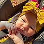 Luciana joined the competition — help win amazing prizes! baby, infant, car_seat, yellow_headband, bow, sunlight, face, hands, cute, child, clothing, seatbelt, closeup, indoors, person, portrait, baby_clothes, headwear, expression, safety