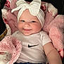 Luciana joined the competition — help win amazing prizes! baby, smile, headband, bow, blanket, pink, onesie, nike, clothing, infant, cute, happy, face, child, soft, plush, couch, portrait, sitting, blue_shorts