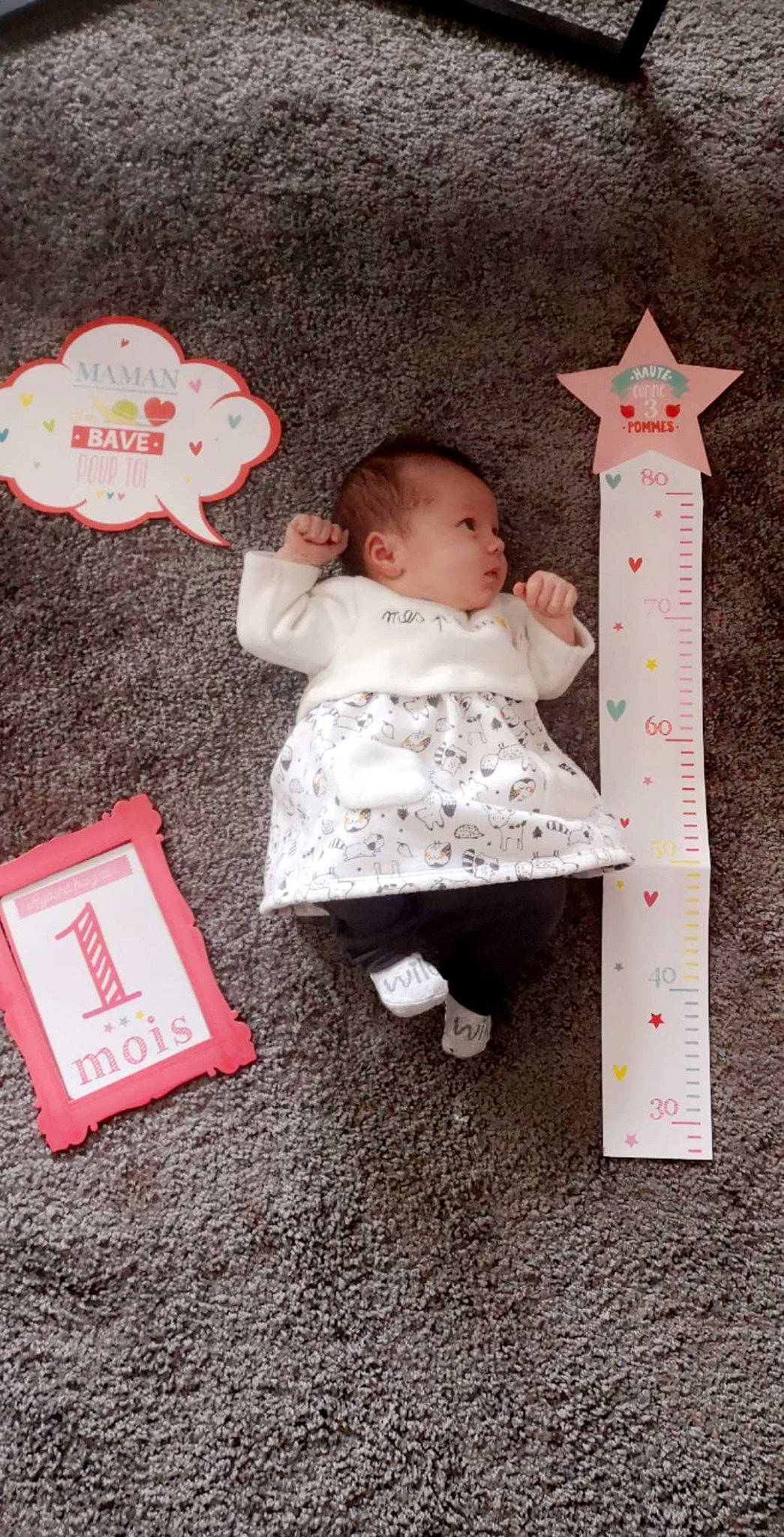 Rosie participe au concours pour gagner de l'argent avec cette photo : baby, baby_products, baby_toddler_clothing, baby_toys, carmine, child, comfort, linens, measuring_instrument, pattern, person, pink, play, room, ruler, sitting, sock, stuffed_toy, textile, toddler