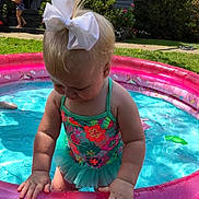 Zoey is registered to the contest to win money with this photo: baby, child, fun, games, inflatable, leisure, pink, play, recreation, smile, summer, swimming_pool, toddler, water
