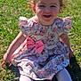 bow, child, curly_hair, cute, dress, flower_pattern, girl, grass, happy, nature, outdoor, pink, playful, portrait, sitting, smiling, sunlight, toddler, white_shoes, white_tights
