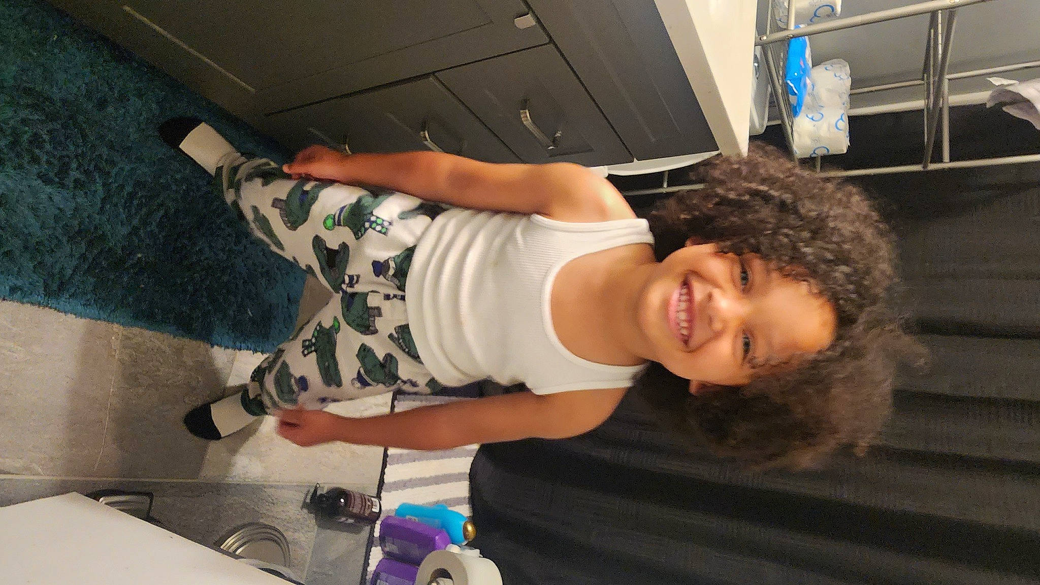 Harrison is registered to the contest to win money with this photo: abdomen, audio_equipment, black_hair, chest, cool, elbow, eyewear, flash_photography, flooring, fun, human_leg, joy, leg, leisure, long_hair, person, sink, smile, t_shirt, thigh