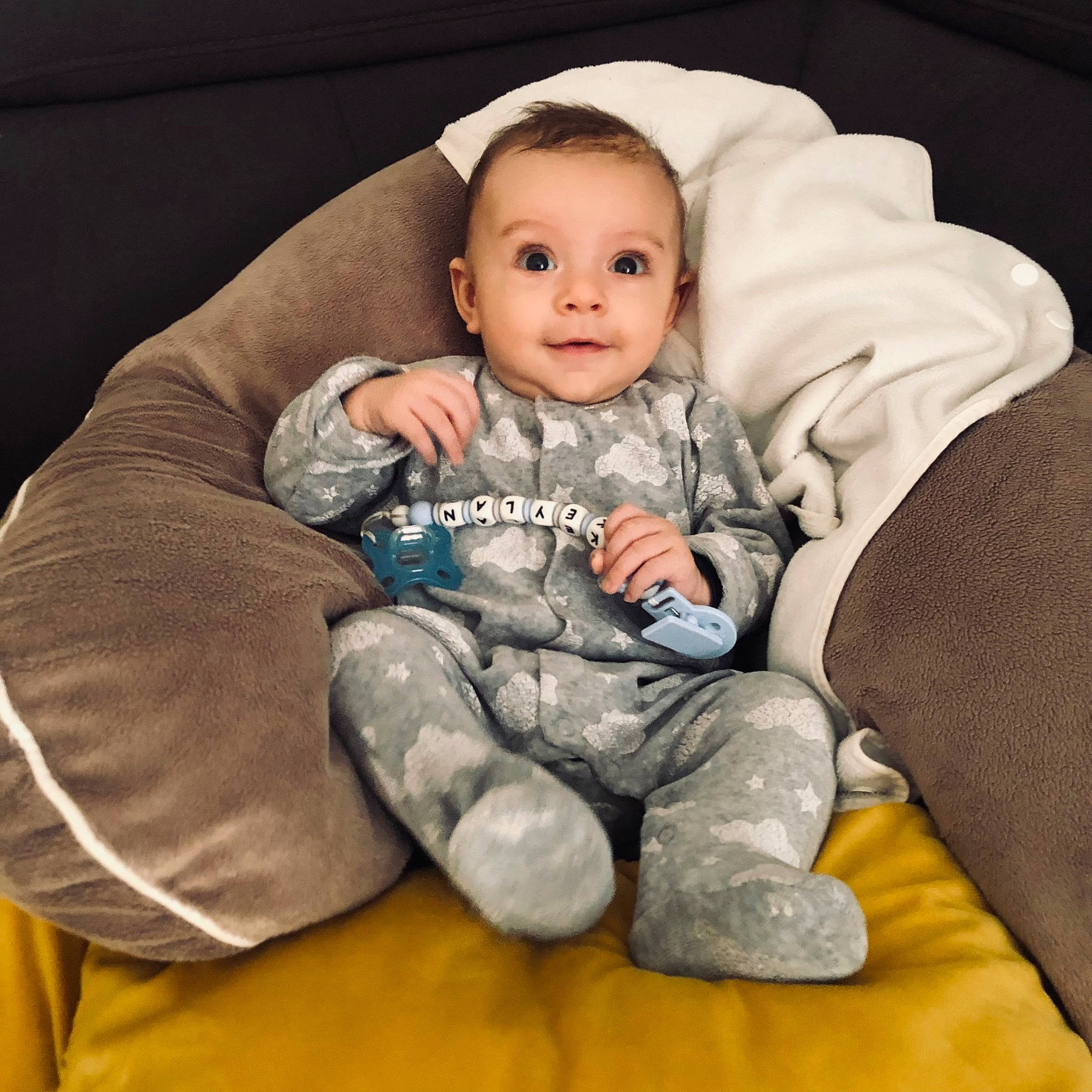 Keylan participe au concours pour gagner de l'argent avec cette photo : arm, baby, baby_products, baby_toddler_clothing, cheek, comfort, couch, eye, face, flash_photography, fun, hair, happy, head, lap, person, sitting, sleeve, smile, textile