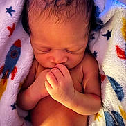 Tyhir is registered to the contest to win money with this photo: newborn, baby, infant, sleeping, blanket, rocket_ship, pattern, soft, cute, peaceful, skin, hand, fingers, child, portrait, closeup, indoors, warm, resting, wrapped