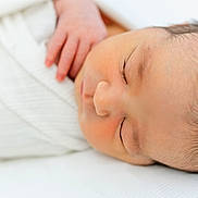 Bodie is registered to the contest to win money with this photo: baby, blanket, calm, child, close_up, cute, face, hand, human, indoors, infant, newborn, peaceful, portrait, resting, skin, sleeping, soft_light, white, young