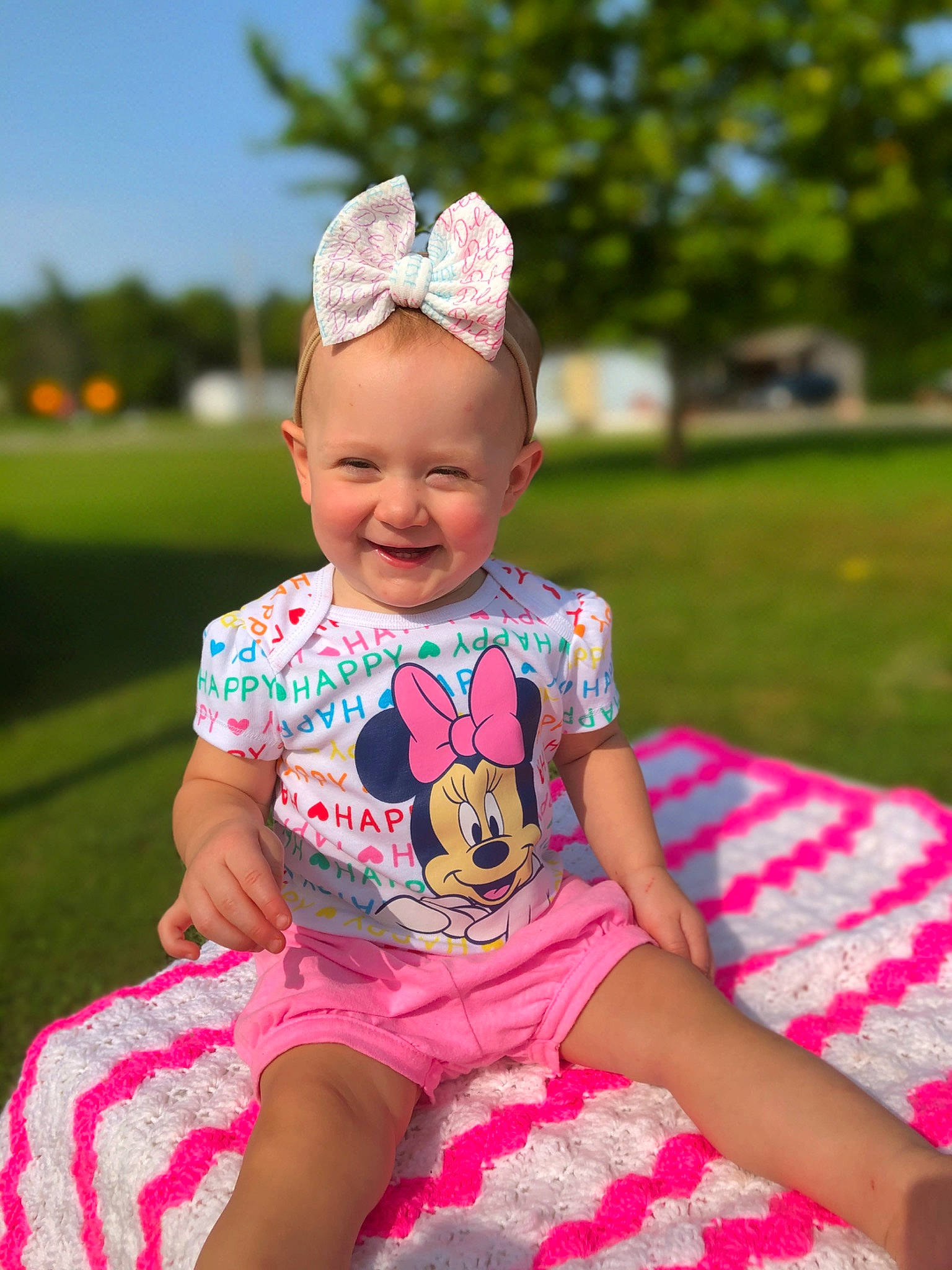 Delilah is registered to the contest to win money with this photo: baby, baby_toddler_clothing, child, design, dress, fashion_accessory, grass, hair_accessory, happy, headband, headgear, joy, pattern, person, photography, pink, recreation, sitting, summer, toddler