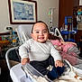 Anthony is registered to the contest to win money with this photo: baby, bassinet, blanket, care, child, clothing, furniture, happy, healthcare, hospital, indoor, infant, medical_equipment, medicine, patient_bed, person, portrait, room, smiling, socks
