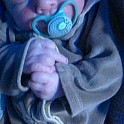 Maël participe au concours pour gagner de l'argent avec cette photo : baby, sleeping, pacifier, hand, clothing, blanket, blue_light, infant, cute, peaceful, soft_texture, closeup, face, newborn, portrait, cozy, wrapped, child, tiny_hands, resting