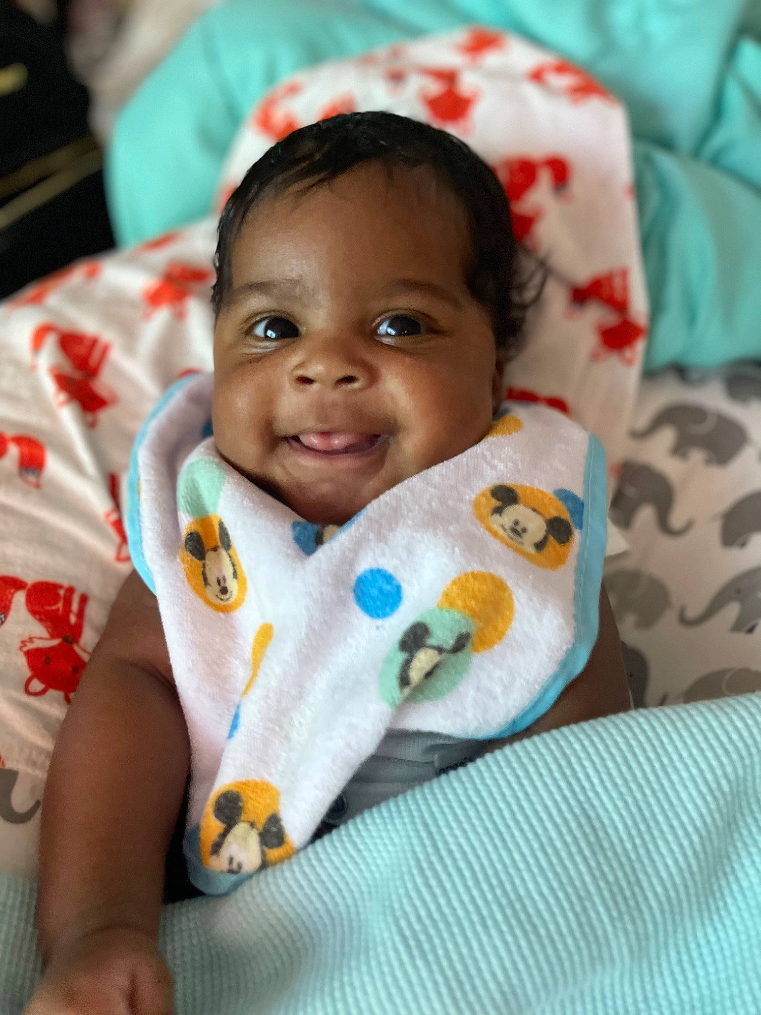 Ashton is registered to the contest to win money with this photo: baby, baby_toddler_clothing, cheek, child, chin, comfort, eye, happy, head, iris, linens, mammal, nose, person, room, sitting, skin, sleeve, smile, textile