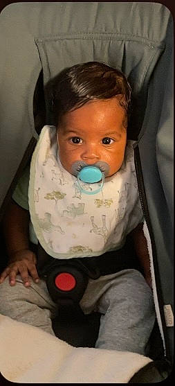 Ashton joined the competition — help win amazing prizes! baby, baby_products, baby_safety, baby_toddler_clothing, bib, cheek, child, comfort, eyelash, finger, human_body, linens, lip, mouth, nose, person, room, sitting, skin, sleeve