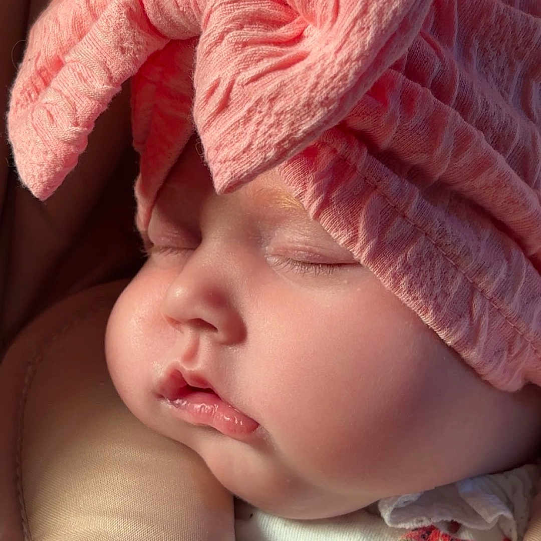 Scarlett is registered to the contest to win money with this photo: baby, bed, blanket, bonnet, cap, clothing, cushion, face, furniture, glove, hat, head, homedecor, newborn, person, photography, portrait, quilt, sleeping, towel