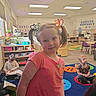 child, girl, classroom, children, reading, colorful, hair_ties, pigtails, carpet, books, education, indoor, playful, smile, furniture, table, chair, learning, kids, preschool