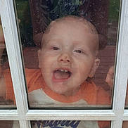 Zaidyn is registered to the contest to win money with this photo: child, toddler, window, glass, reflection, face, hands, smiling, playful, outdoor, dirty_window, shirt, person, curiosity, portrait, closeup, expression, daylight, casual, candid