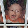 candid, casual, child, closeup, curiosity, daylight, dirty_window, expression, face, glass, hands, outdoor, person, playful, portrait, reflection, shirt, smiling, toddler, window