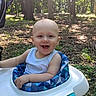 baby, blue, child, cute, daylight, forest, fun, green, happy, infant, nature, outdoor, play, portrait, seat, smiling, sunlight, trees, walker, white