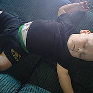 Zaidyn joined the competition — help win amazing prizes! baby, sleeping, couch, child, relaxed, indoor, peaceful, casual_clothing, black_shirt, shorts, toddler, resting, soft_light, furniture, home, comfort, skin, head, face, arm